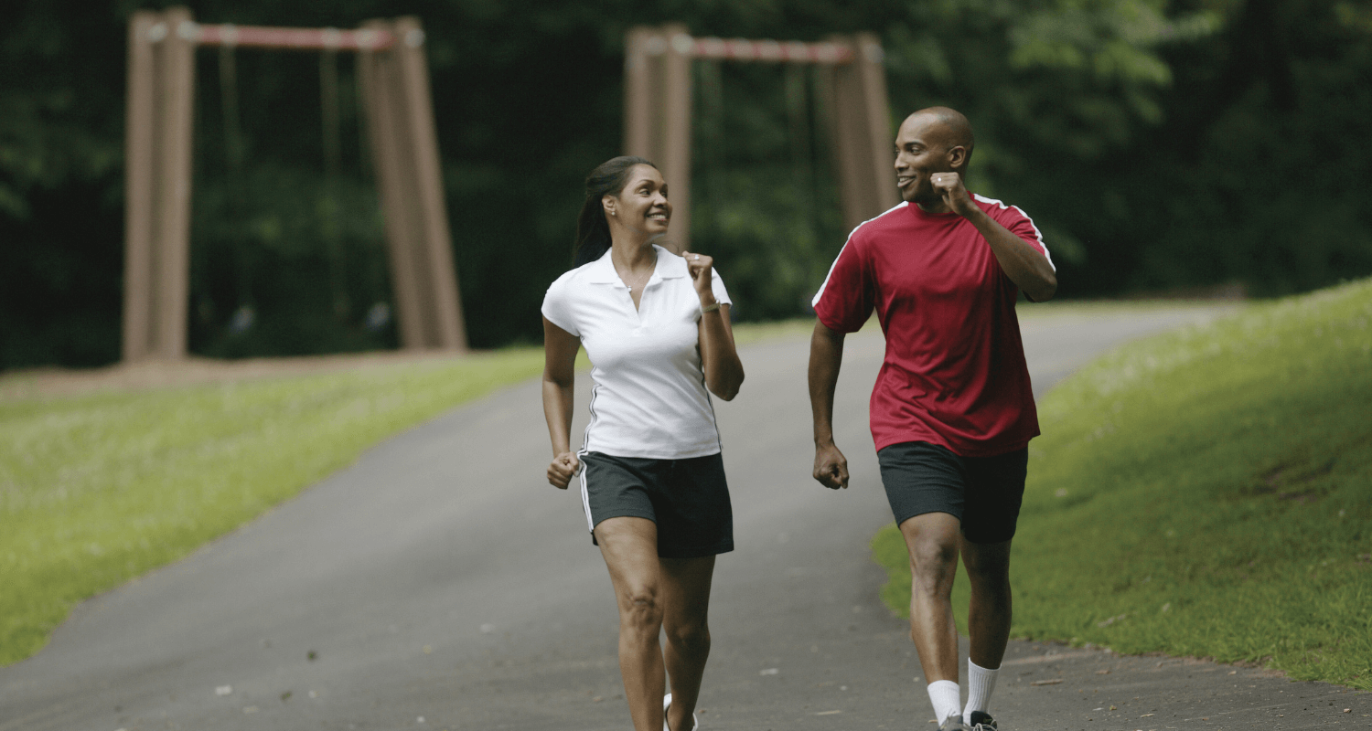 Couple jogging in the park to reduce hypercholesterol